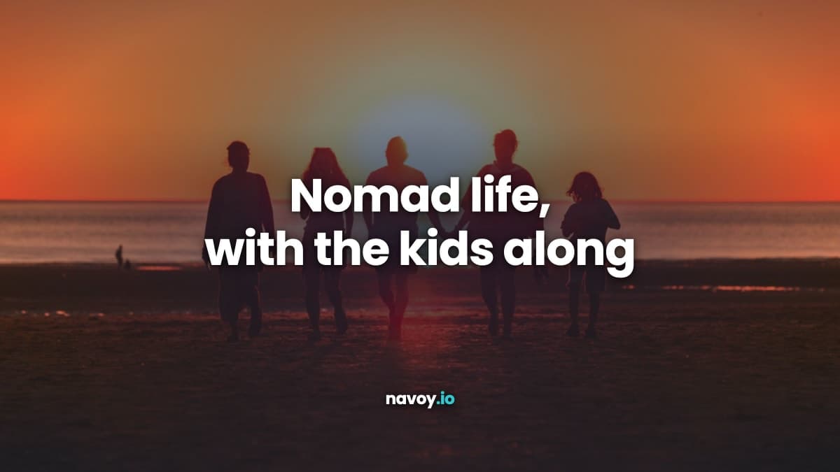 Silhouette of a family walking on a beach at sunset