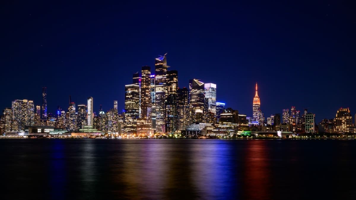 Midtown Manhattan skyline at night with the Empire State Building, seen across the Hudson River