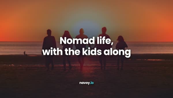 Silhouette of a family walking on a beach at sunset